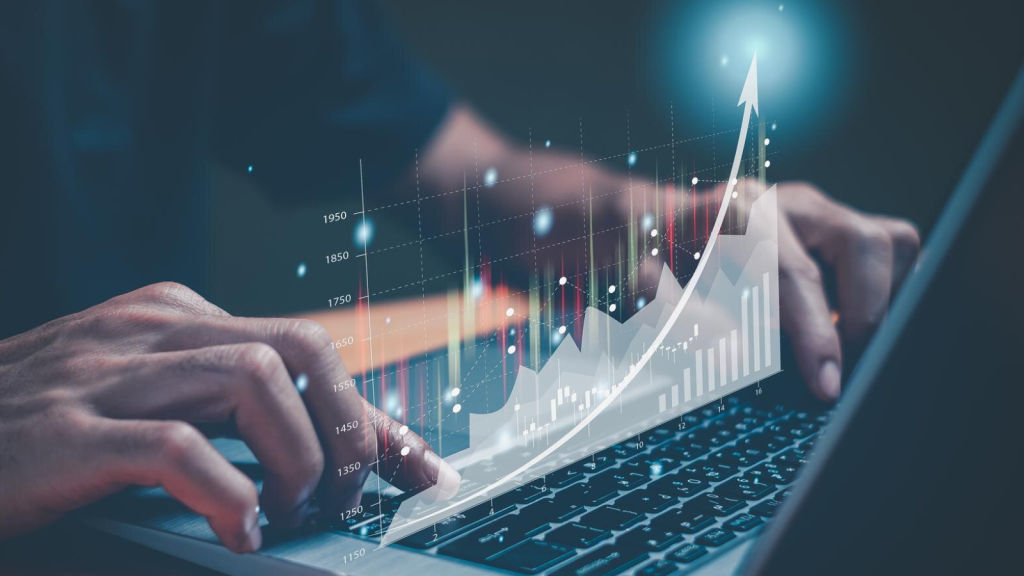 Hands typing on laptop with rising data graph, illustrating business internet Sugar Land supporting growth, analytics, and high-speed performance.