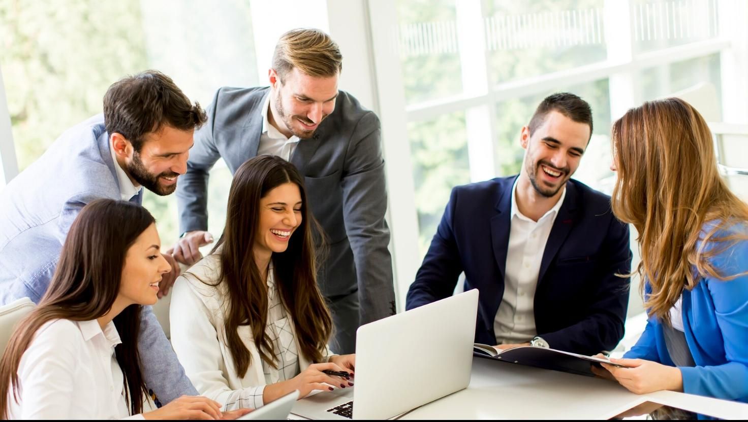 Employees of a Houston business collaborating with ease because of VoIP. Shows flexibility for all types of businesses.