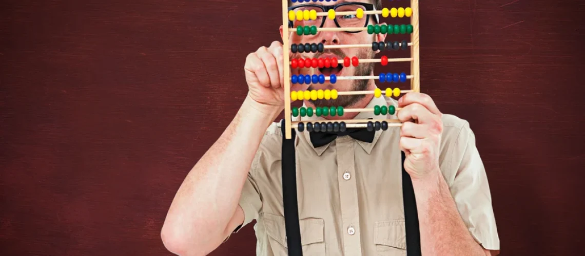 Geeky-hipster-holding-an-abacus-against-desk
