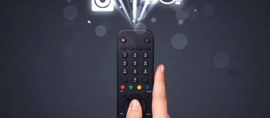 Hand-holding-a-remote-control-media-icons-coming-out-of-it