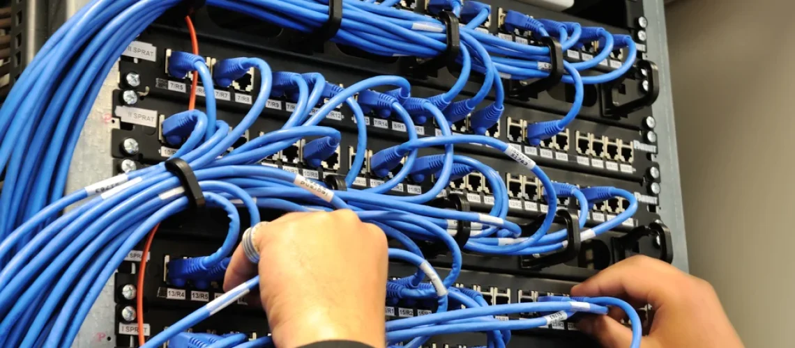 Man-connecting-network-cables-to-switches
